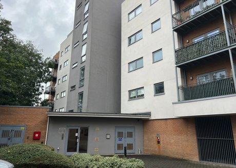 Contemporary apartment buildings of several storeys, with rendered walls, balconies and a single-storey entrance block.
